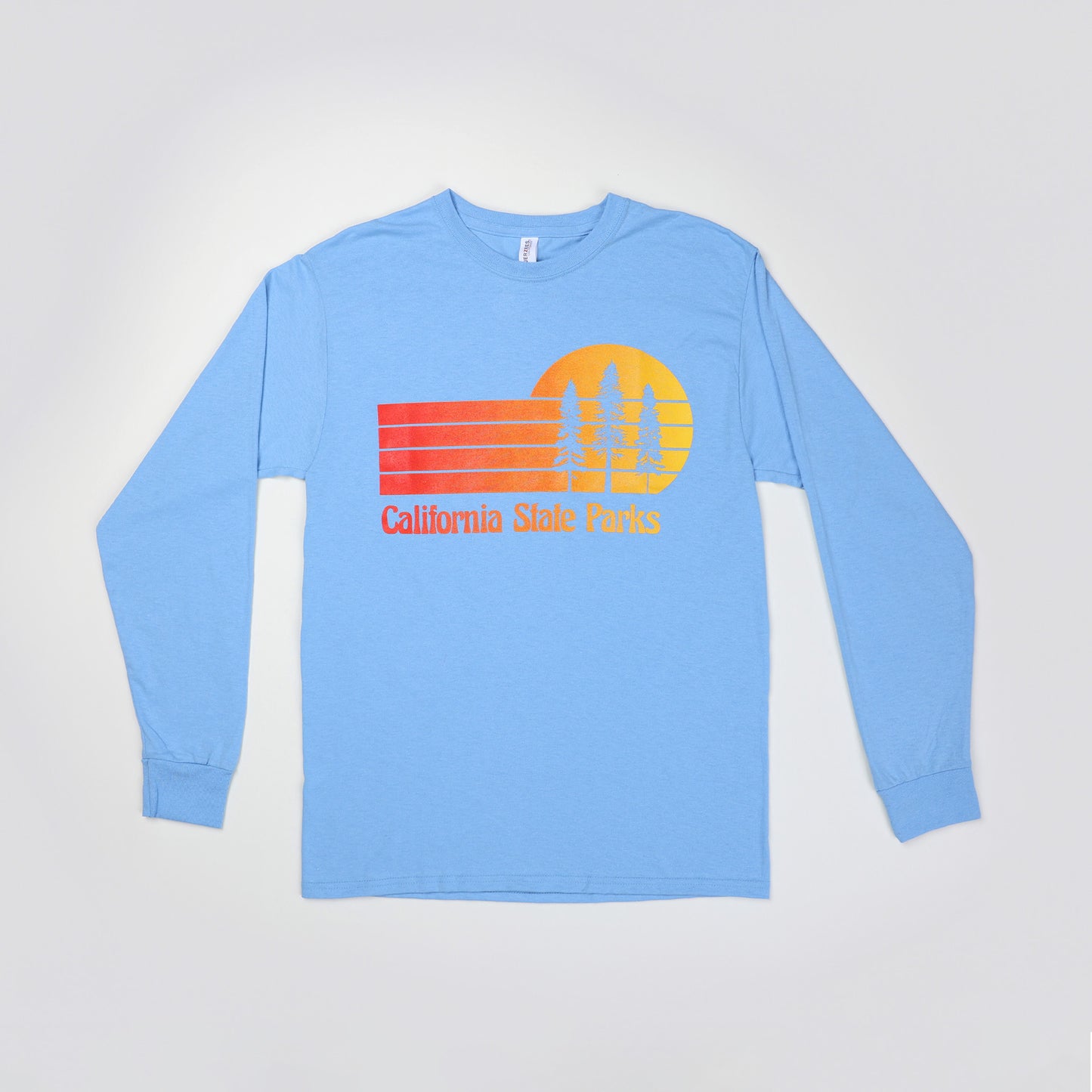 a long sleeve, light blue t-shirt featuring a retro sunset design with three Redwood trees