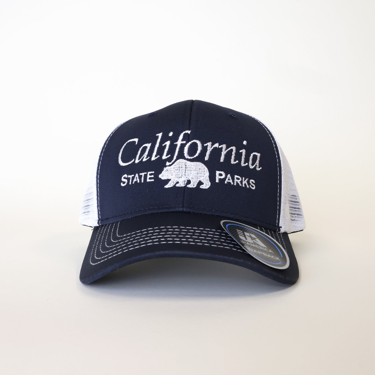 a navy blue trucker hat with white mesh and the words California State Parks