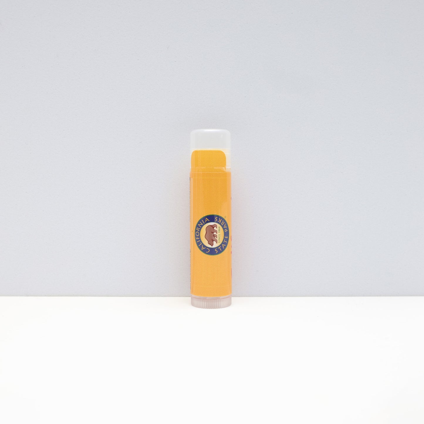 a yellow tube of lip balm with the California State Parks logo