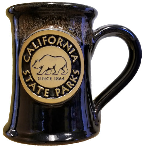 a dark colored, hand-thrown mug with a raised California State Parks logo